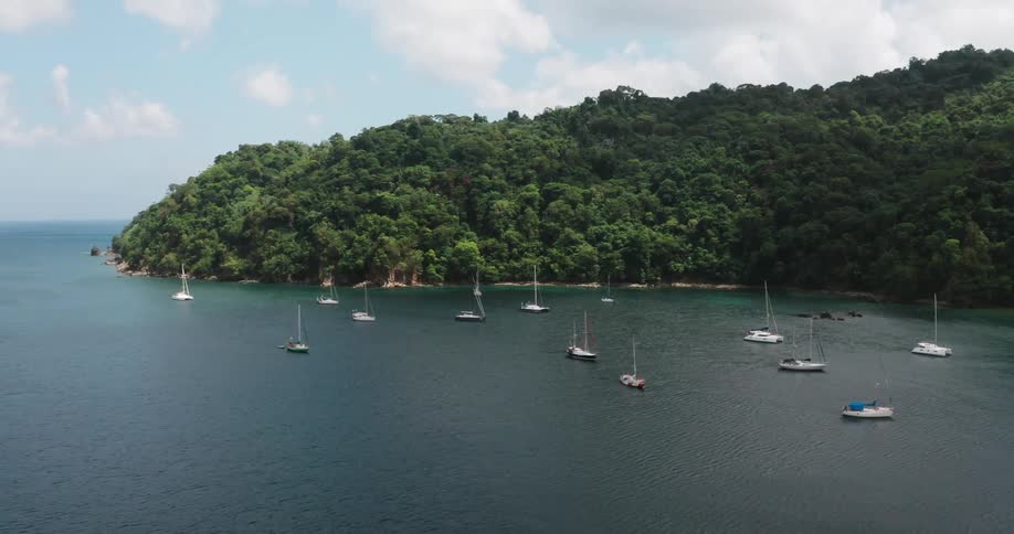 Sailboats anchored on tropical island