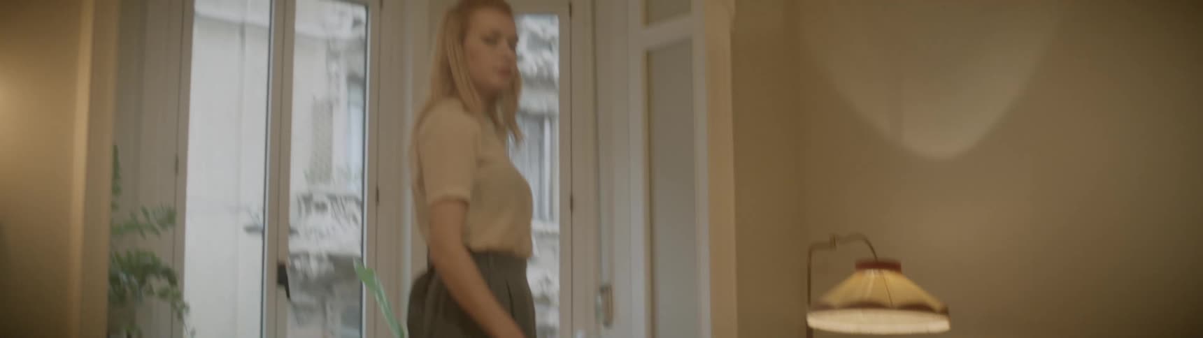 A woman pushes an electric steam mop back and forth on a floor
