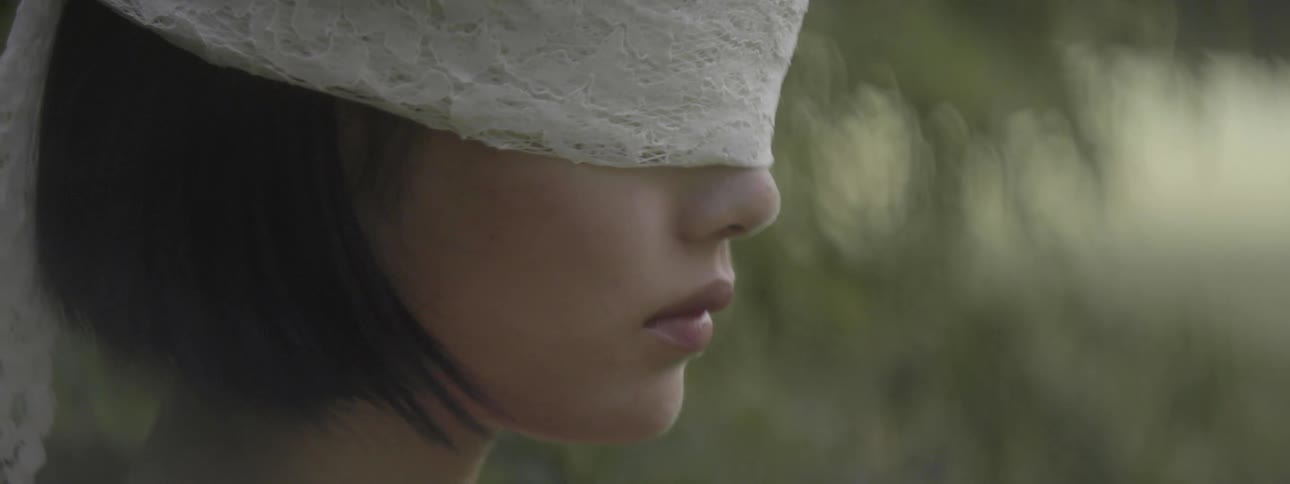 Young woman wearing lace blindfold