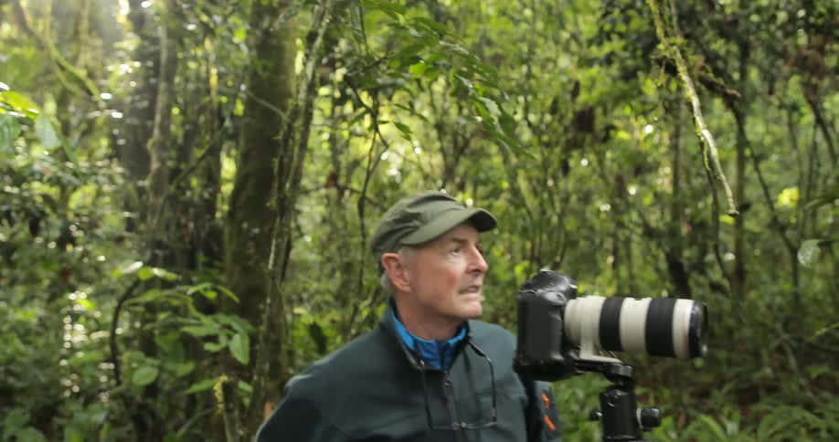 A man taking pictures in a forest