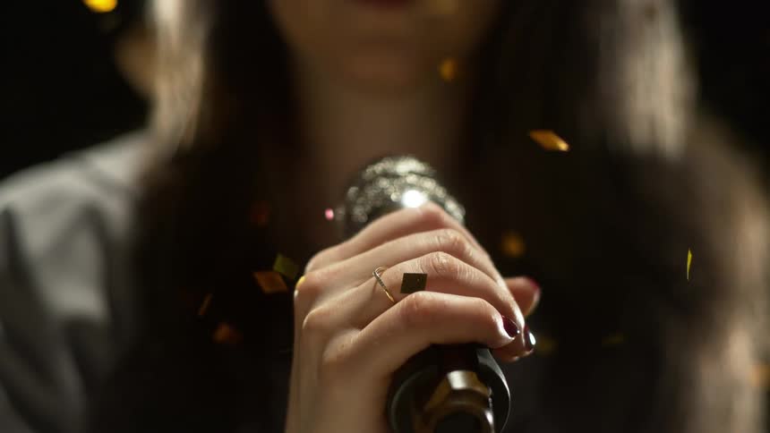 A woman is holding a microphone
