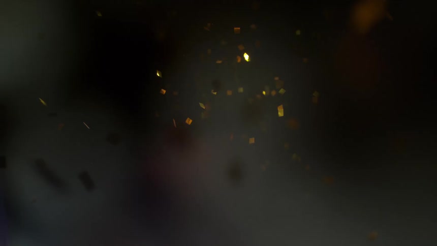 Gold confetti falls through the air