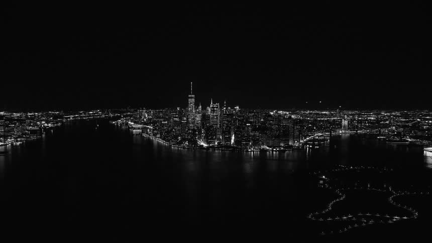Black and white aerial view of city skyline at night