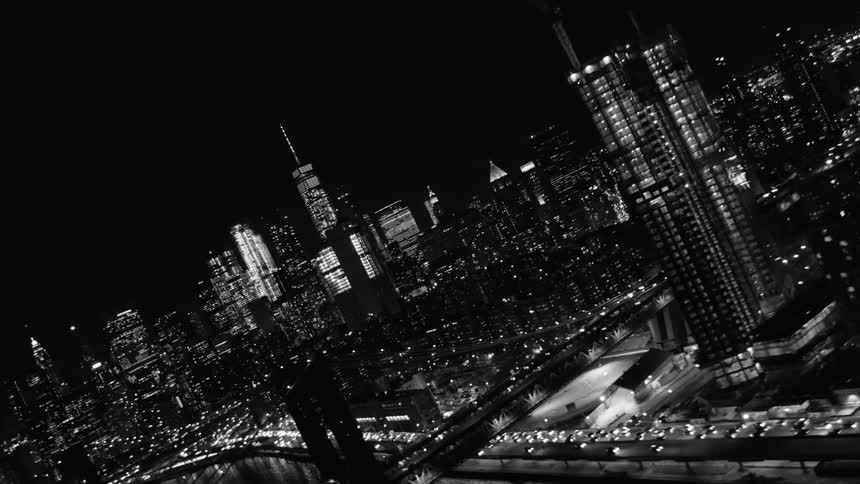 Black and white footage of large city at night