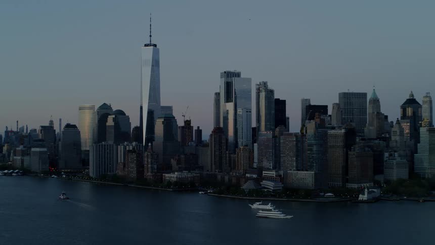 A large downtown area sits on a shoreline with the ocean