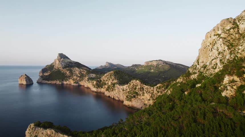 A mountainous promontory juts out into the ocean