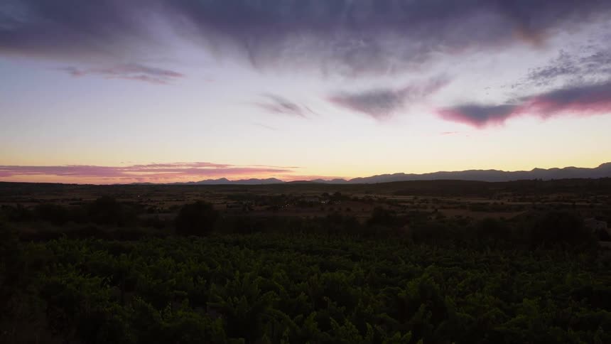 The sun rises over a rural neighborhood surrounded by flat ground