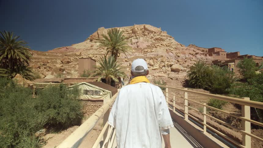 A man walks across a bridge