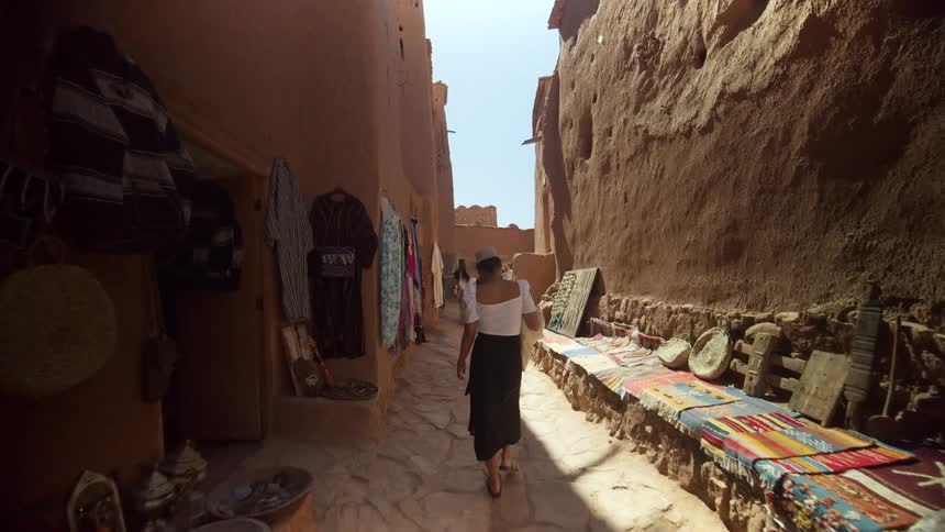 A woman walks through an outdoor market