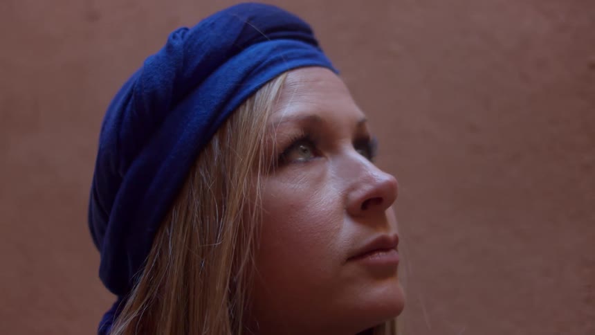 Young woman with blue scarf wrapped around head