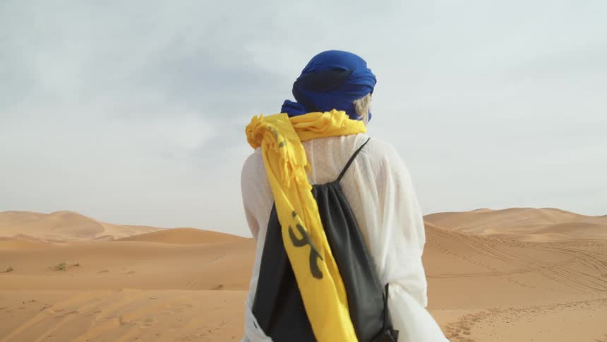 A person is traveling through the desert
