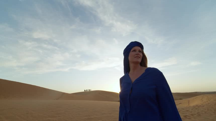 A woman is standing in the desert
