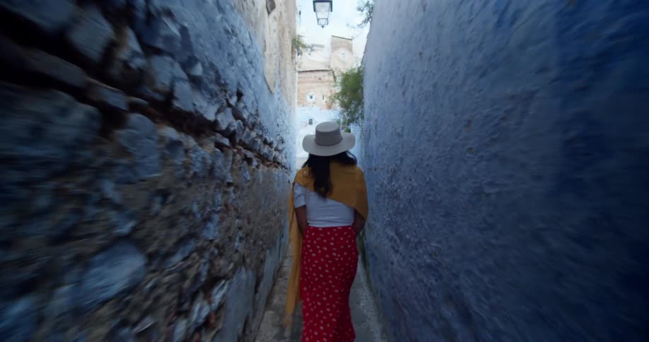 The woman walks between the walls