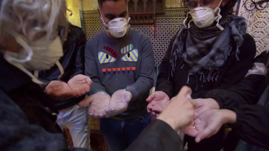 Group of friends apply hand sanitizer