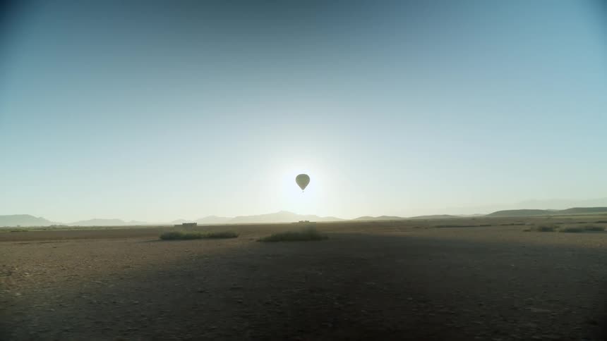 An hot air balloon is in the clear sky