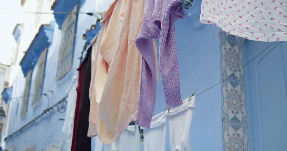 Clothes drying on clothes line outside of apartment building