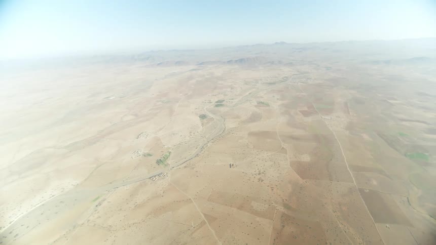 The earth with forests and mountains and soil spreads out from a great height all the way to the horizon