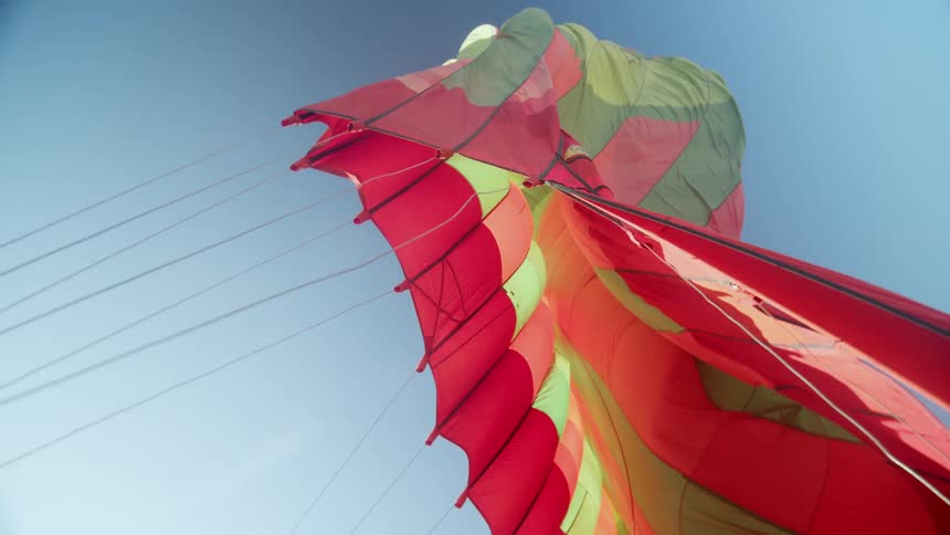 The kite flies high in the sky
