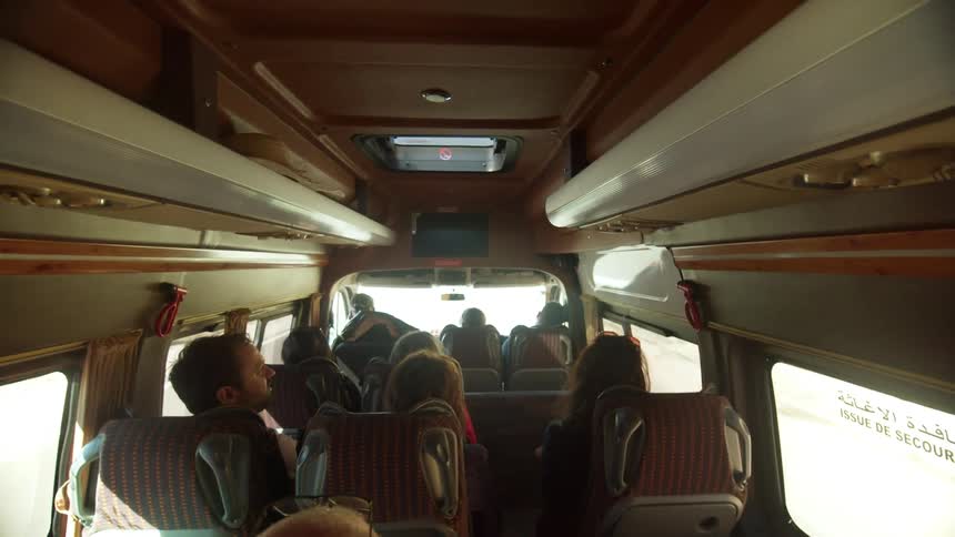 Group of people riding in small bus