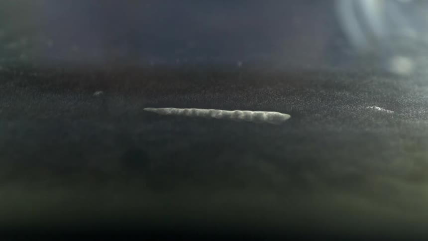 The small item sinks into the darkness