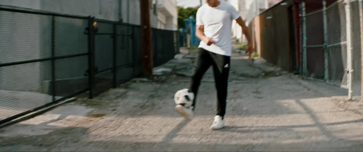 A guy is playing soccer outdoors