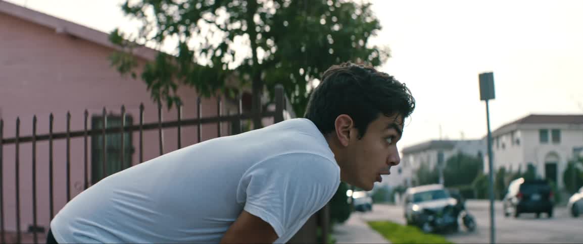 A teenager runs down an alley