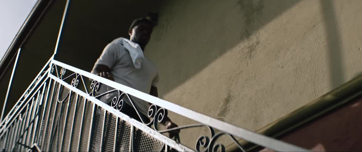 Man walking down external staircase outside of building