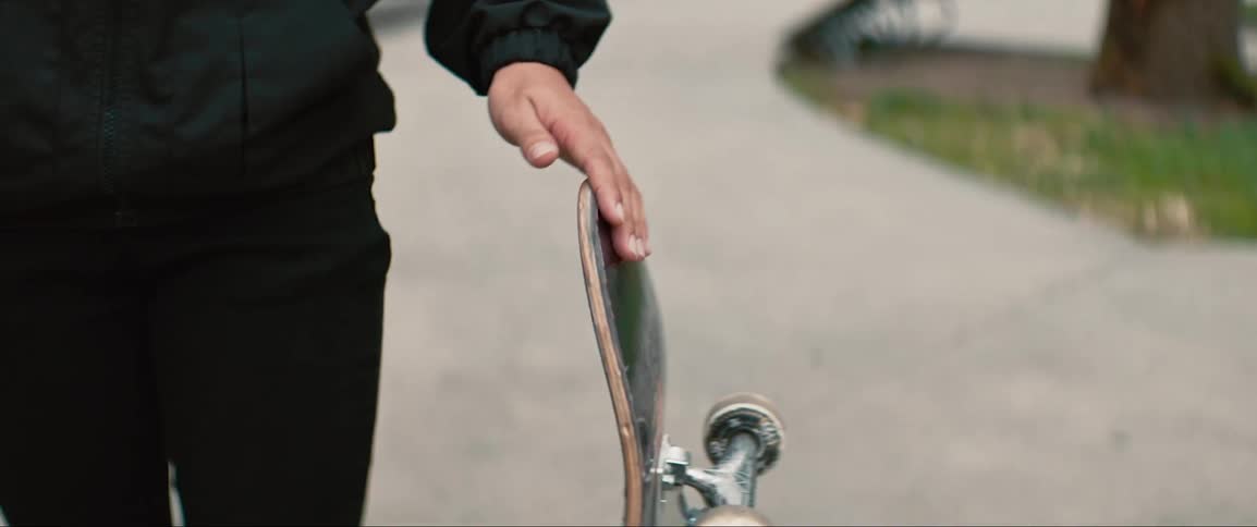 A man has a skateboard outdoors