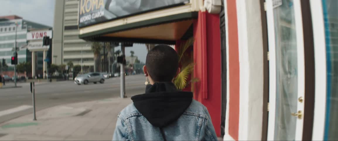 A woman is walking in a downtown city
