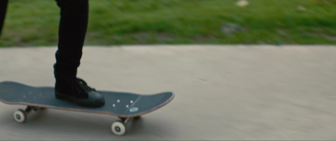 A white female skateboard rides up a ramp and then reverses course and ends up taking a fall