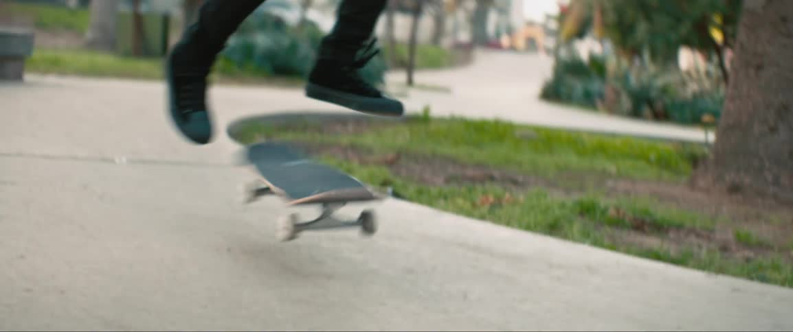 Female skateboarder rides on a skateboard in the public park