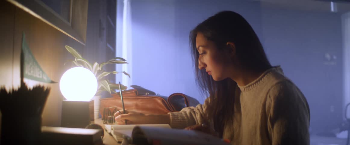 Woman sitting at the desk studies in her room