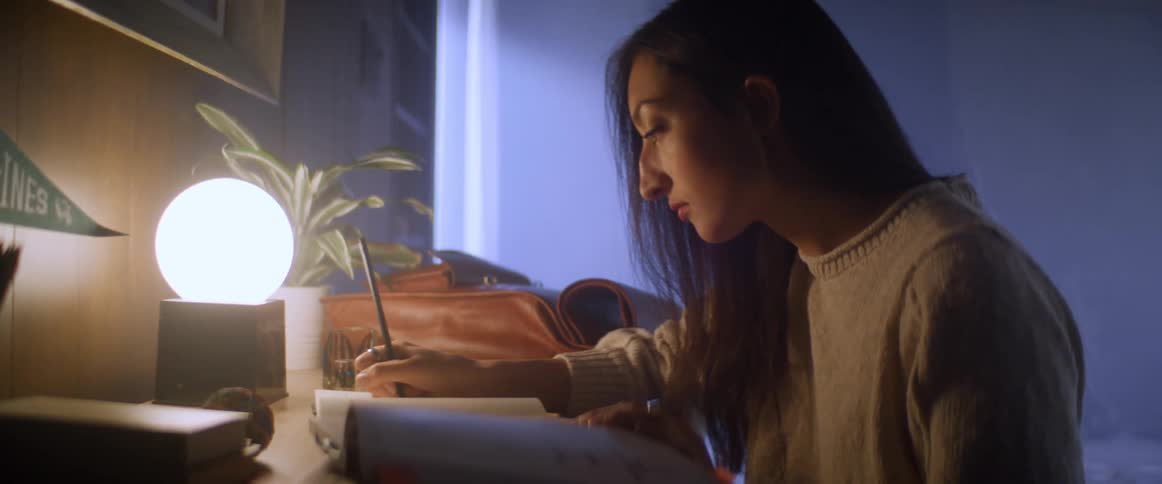 Woman studies in her room