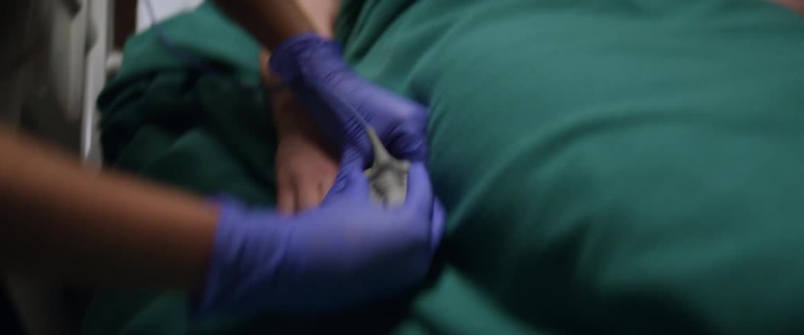 Nurses help a patient in the hospital bed