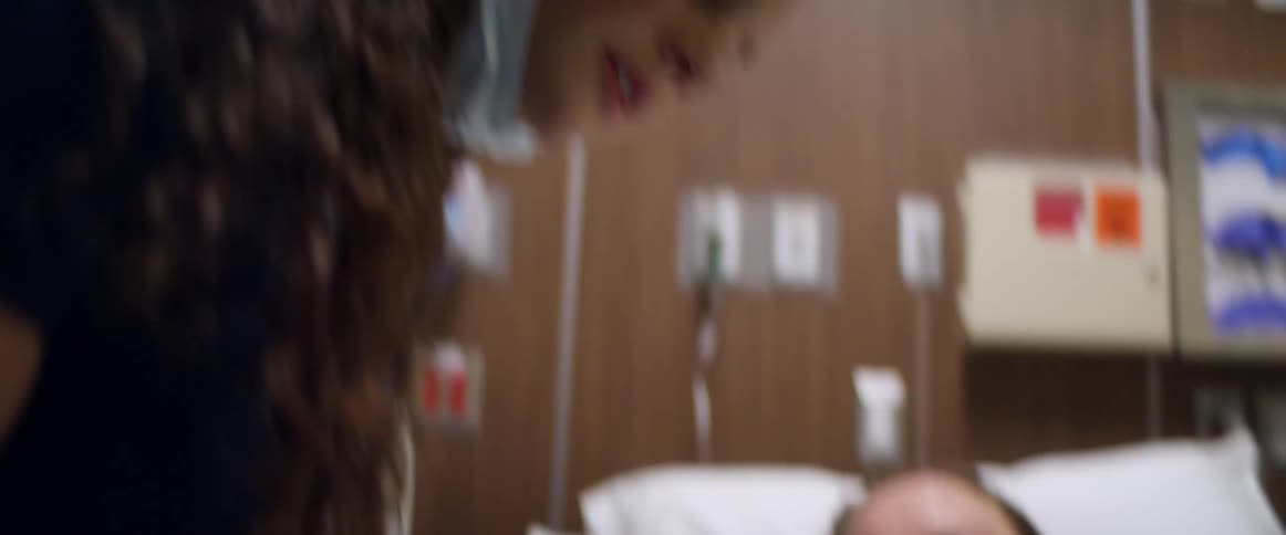 Two nurses help a patient in the hospital