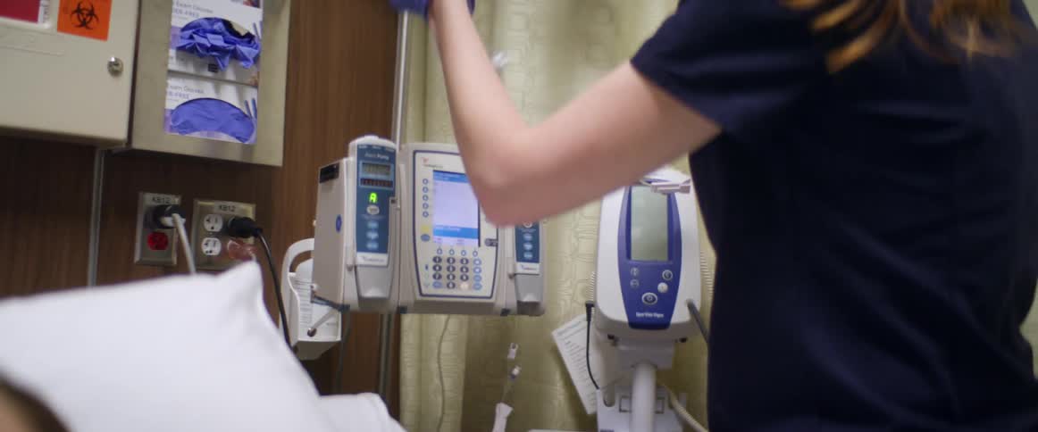 A nurse in a hospital tending to a patient