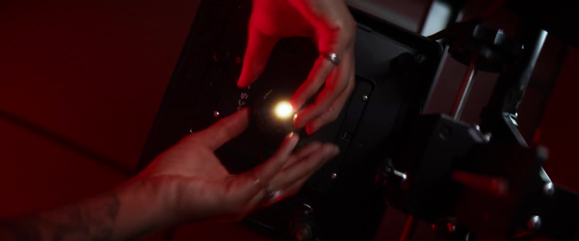 A white woman puts a piece on a scientific device and turns it