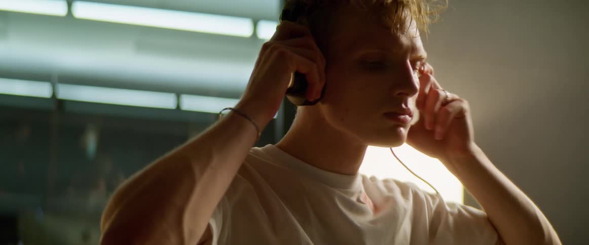 Man wears headphones to listen to music