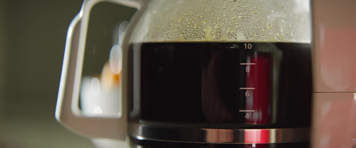 Coffee is being brewed by a coffee machine