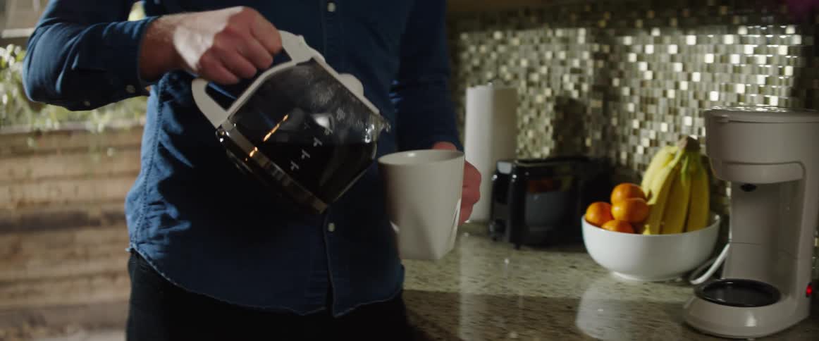 A man pours a cup of coffee