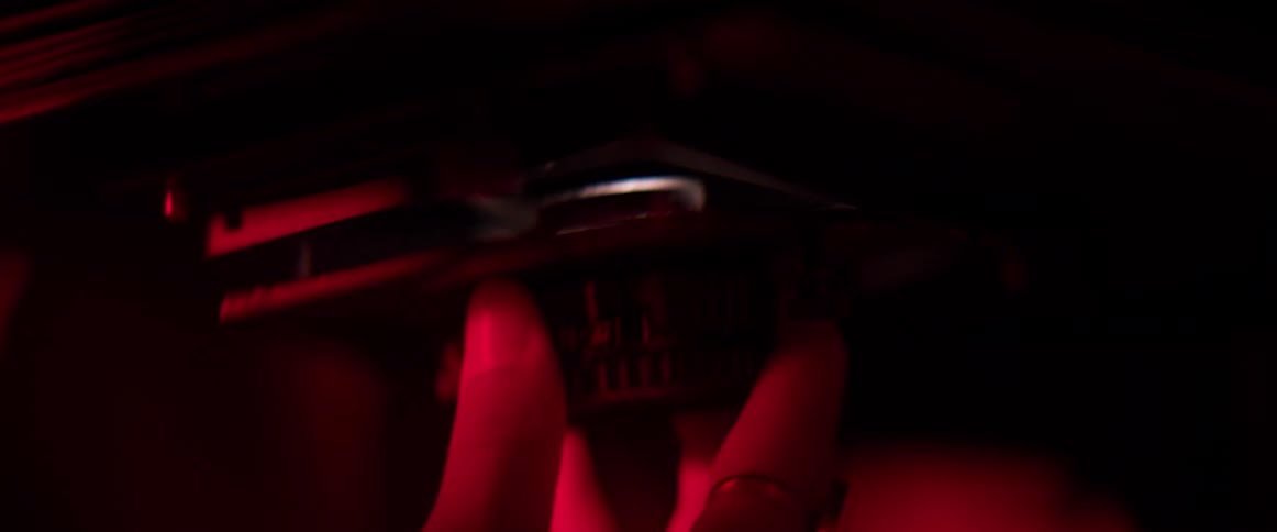 A person is putting film into a camera