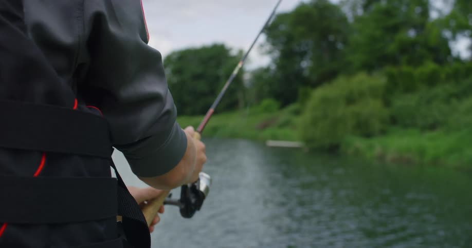 A man casts his rod in to the water