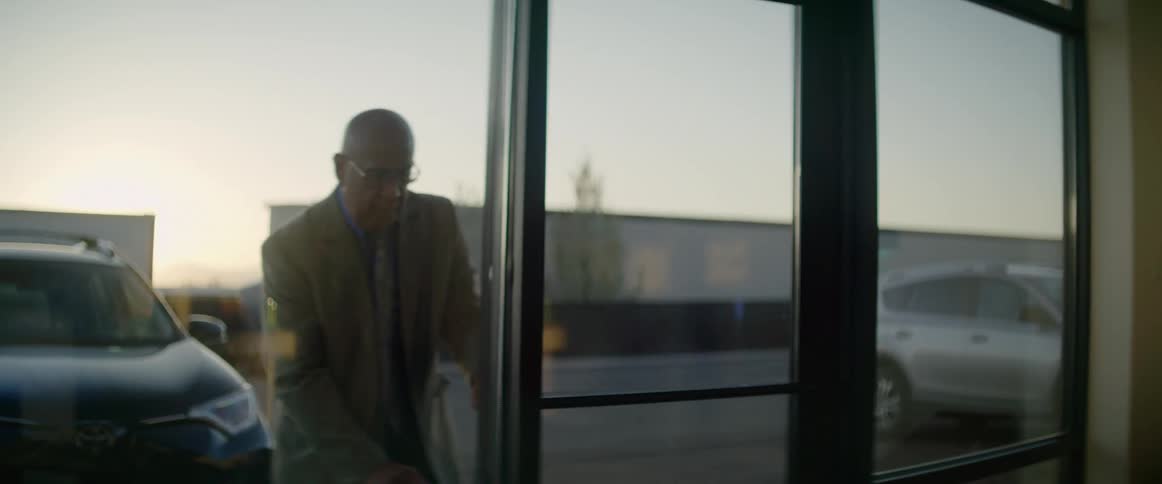 A man unlocks the office door and walks in