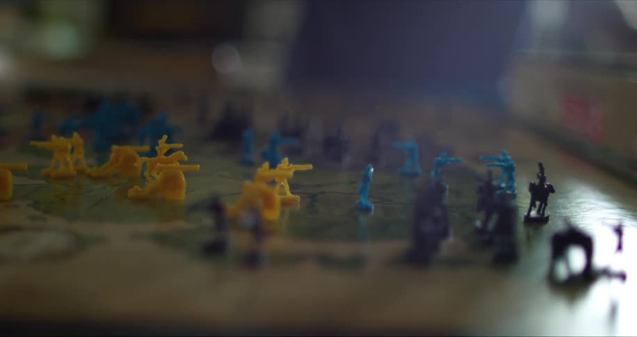 A board game of risk with people in the background
