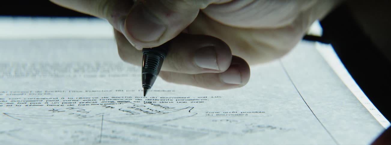 Hand writing notes on sheet of paper