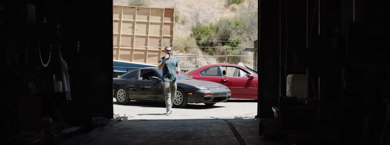 A man walks into the garage