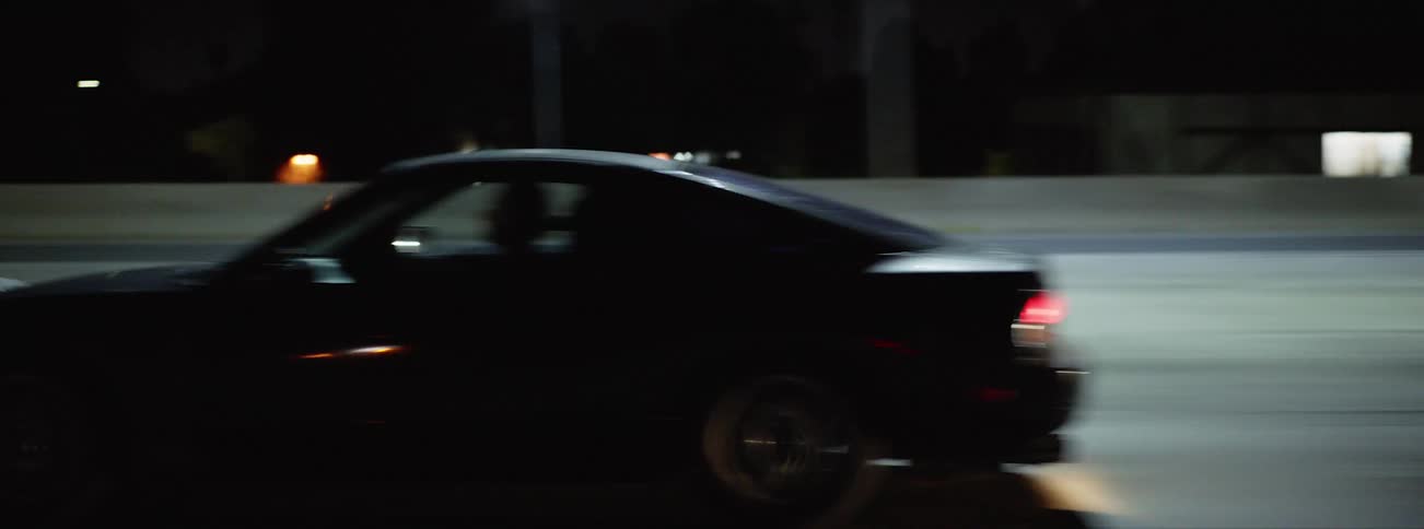 View of car on freeway from window of moving vehicle