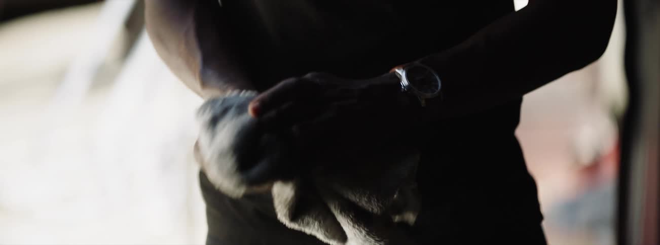 A man wipes his hands with a rag