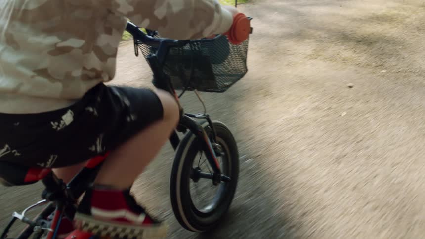 Little child rides a bicycle on the cycle track
