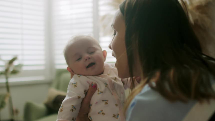 The woman kisses the child